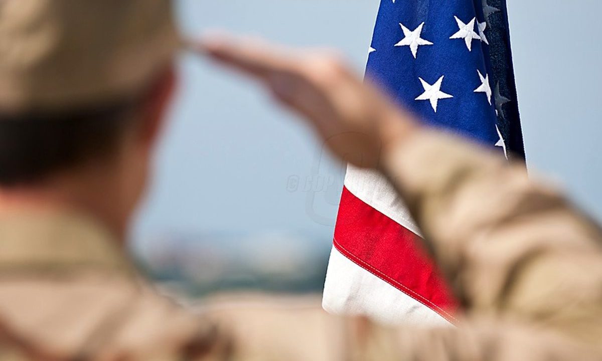 soldier saluting American flag