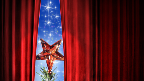 red velvet curtains wtih blue starry background and tree poking through